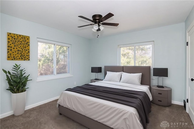 bedroom featuring carpet floors, multiple windows, and baseboards