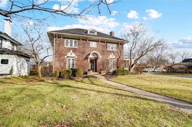 colonial-style house with a front yard, brick siding, and a chimney