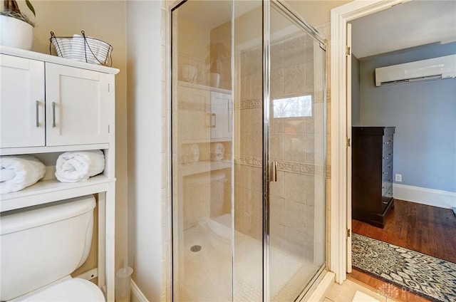 1902 N Fountain Blvd, Springfield, OH 45504 - bathroom featuring a wall unit AC, toilet, a shower stall, and baseboards