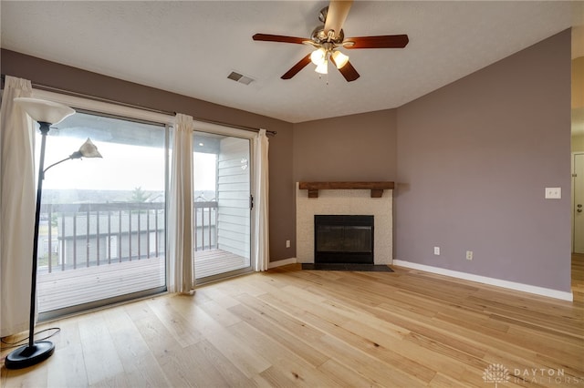 unfurnished living room featuring visible vents, light wood-style floors, a fireplace with flush hearth, ceiling fan, and baseboards