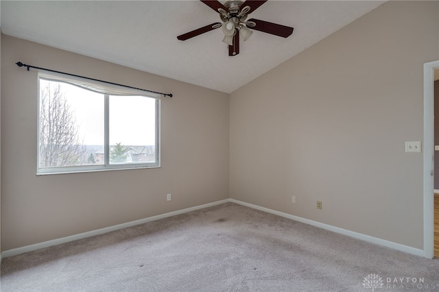 unfurnished room with lofted ceiling, light colored carpet, ceiling fan, and baseboards