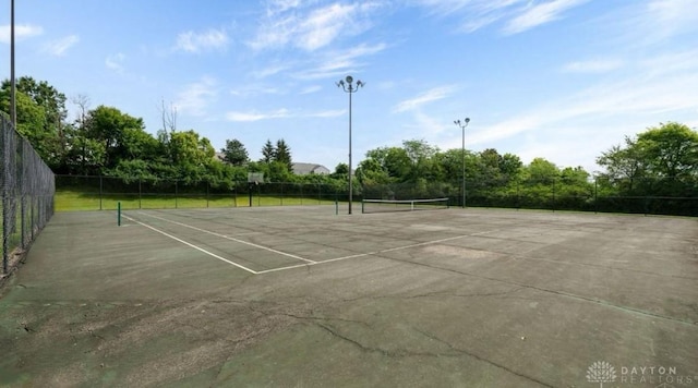 view of tennis court with fence