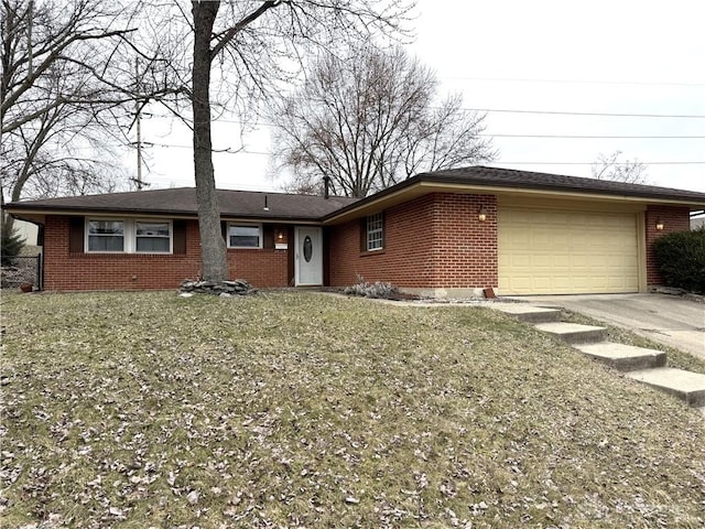 single story home with concrete driveway, brick siding, an attached garage, and a front yard