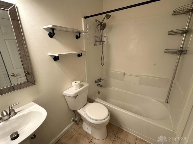 full bathroom with shower / bath combination, toilet, a sink, tile patterned flooring, and baseboards