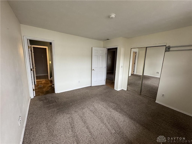 unfurnished bedroom featuring a closet and carpet flooring