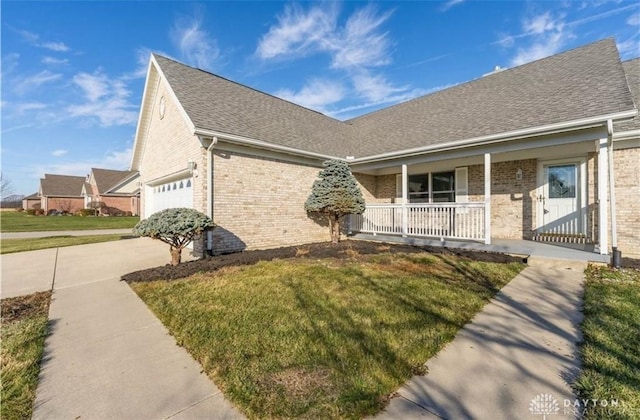 ranch-style house featuring brick siding, a shingled roof, covered porch, driveway, and an attached garage