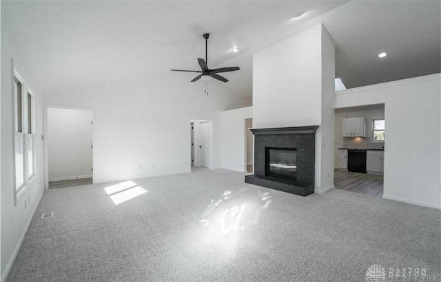 unfurnished living room featuring baseboards, light colored carpet, a fireplace, high vaulted ceiling, and a ceiling fan