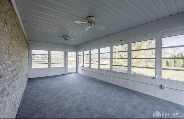 unfurnished sunroom featuring a ceiling fan