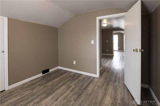 bonus room with vaulted ceiling, dark wood-style flooring, visible vents, and baseboards