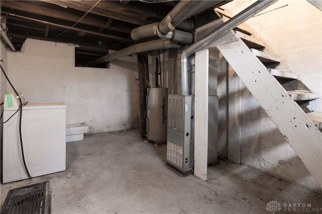 unfinished below grade area featuring water heater and washer / clothes dryer