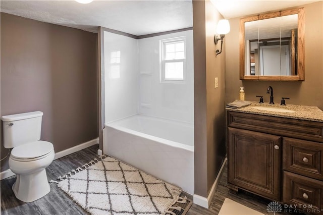 full bath featuring baseboards, vanity, toilet, and wood finished floors