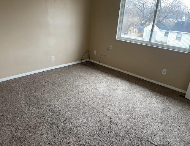 unfurnished room featuring baseboards