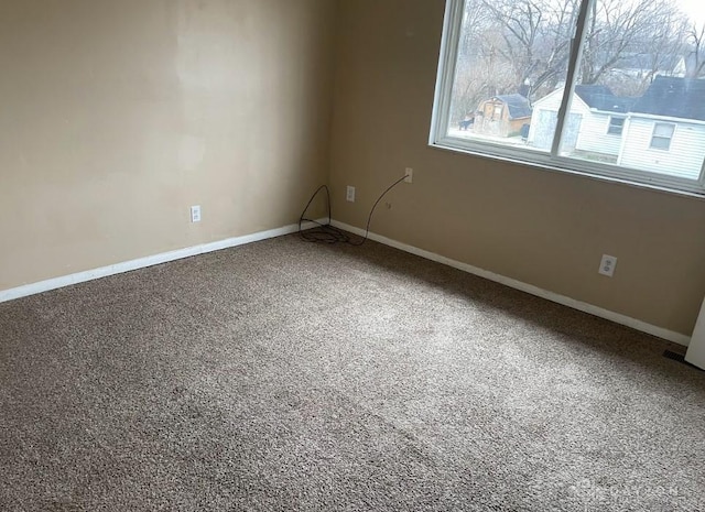 spare room with carpet and baseboards