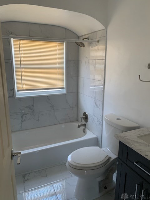 bathroom with toilet, marble finish floor, washtub / shower combination, and vanity