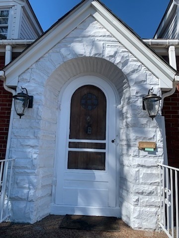 entrance to property with brick siding