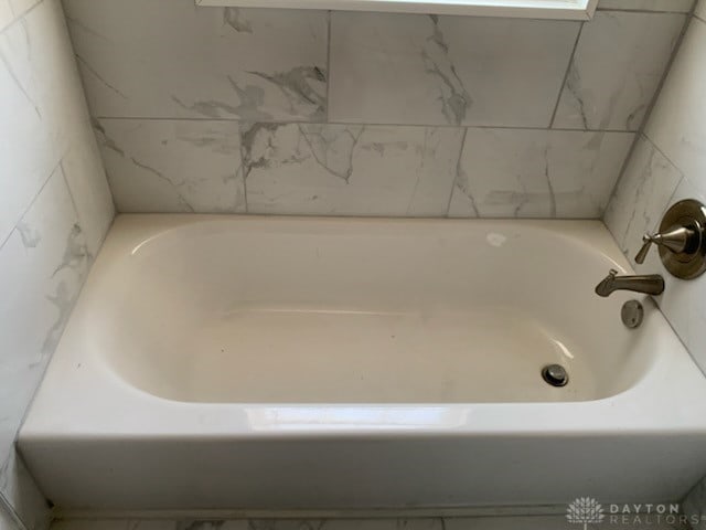 full bathroom featuring a tub to relax in