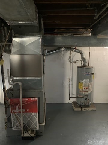 unfinished below grade area featuring water heater