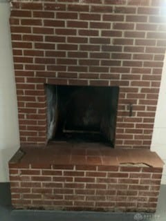 interior details with a fireplace with raised hearth