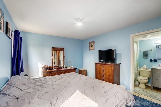 tiled bedroom featuring ensuite bathroom