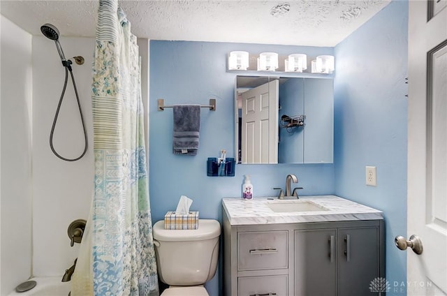 bathroom featuring toilet, a textured ceiling, and vanity