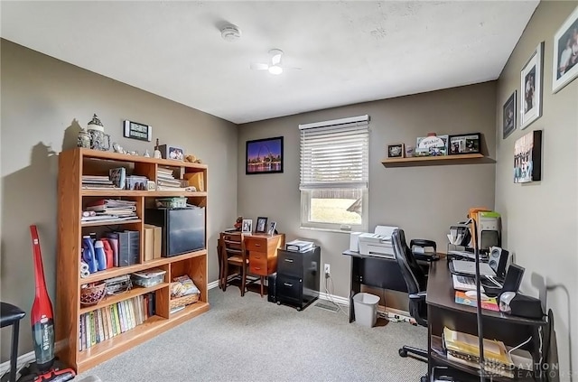 carpeted home office with baseboards