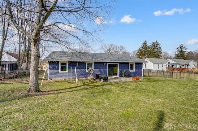 back of property with a chimney, a yard, a patio, and fence