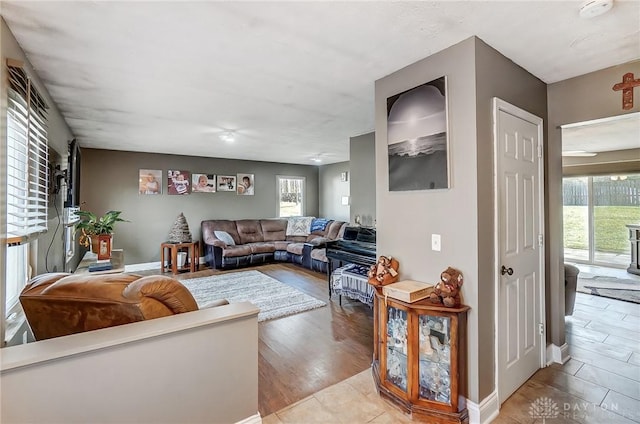 living room with a healthy amount of sunlight, light wood finished floors, and baseboards