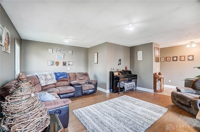 living area featuring baseboards and wood finished floors