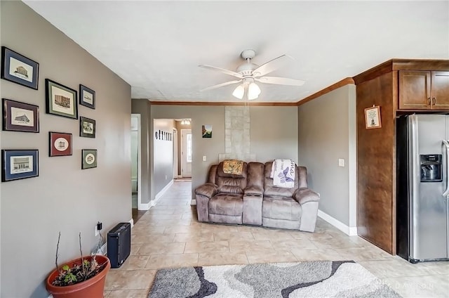 living area with ornamental molding, ceiling fan, and baseboards