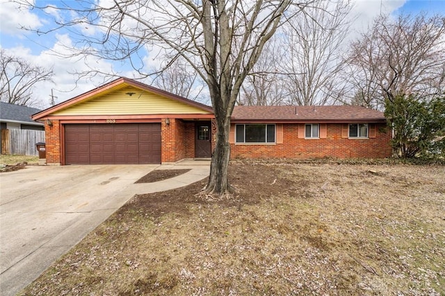 ranch-style house with a garage, brick siding, driveway, and fence