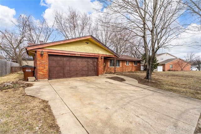 single story home featuring brick siding, a chimney, concrete driveway, an attached garage, and fence