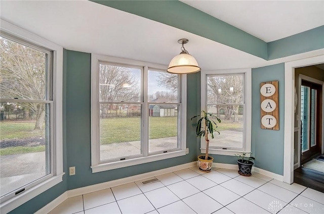 interior space with tile patterned floors, visible vents, and baseboards