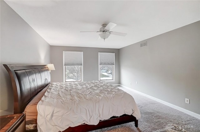 carpeted bedroom featuring baseboards, visible vents, and ceiling fan