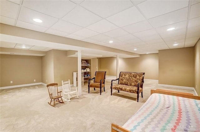 living area featuring carpet, a paneled ceiling, baseboards, and recessed lighting