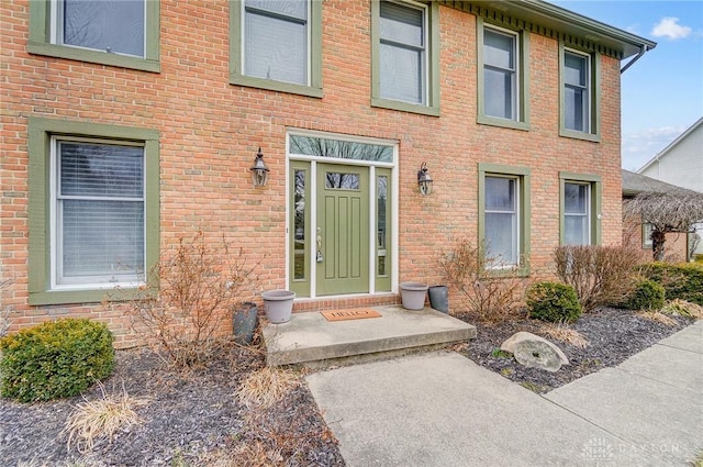 doorway to property with brick siding