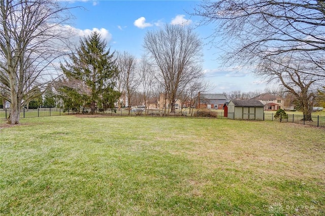 view of yard featuring a shed, an outdoor structure, and a fenced backyard