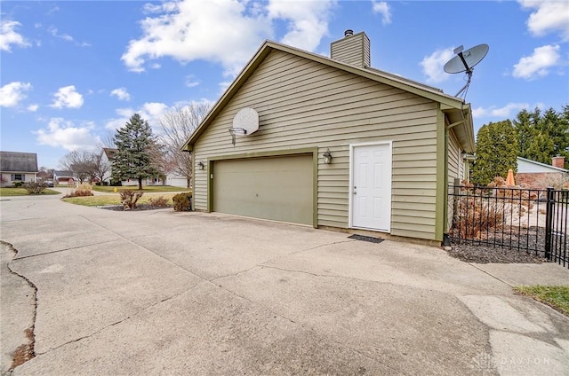 garage with fence and driveway