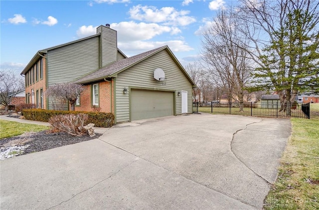 view of side of home featuring brick siding, a chimney, concrete driveway, fence, and a garage