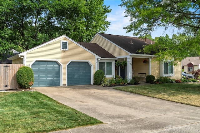 ranch-style house with driveway, a front lawn, an attached garage, and fence