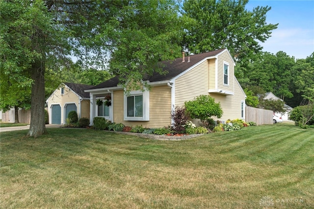 view of front facade featuring a garage, fence, a front lawn, and concrete driveway