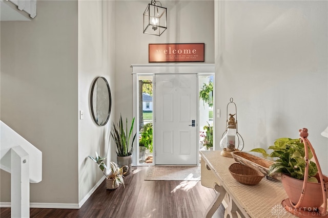 foyer entrance featuring wood finished floors and baseboards