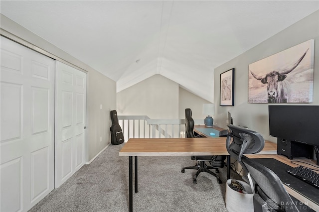 carpeted office space with vaulted ceiling