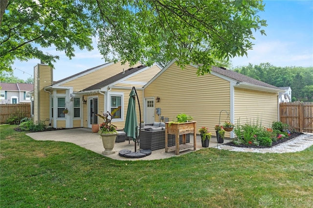 back of property featuring outdoor lounge area, fence, a lawn, and a patio