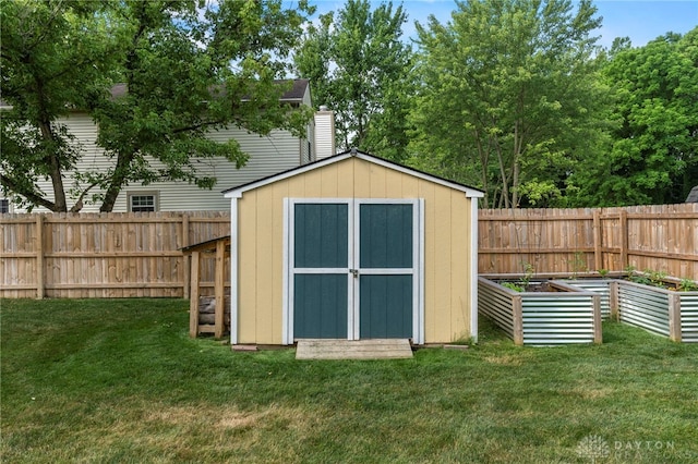 view of shed featuring a fenced backyard and a vegetable garden