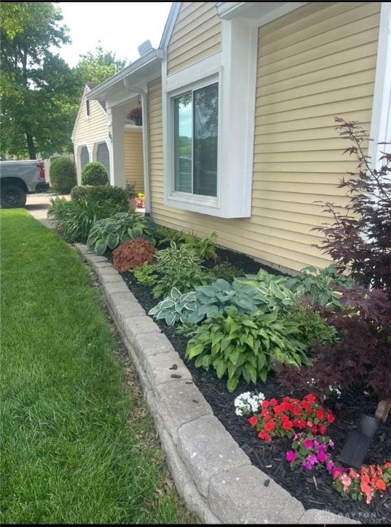 view of side of home with a garage and a yard