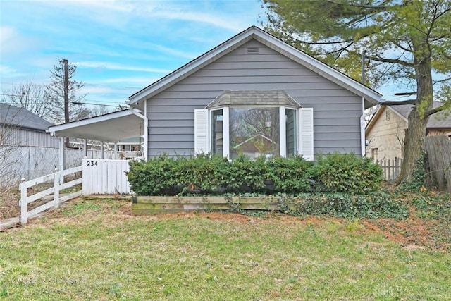 exterior space featuring a carport, fence, and a front lawn