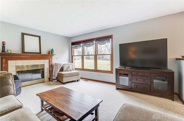 living area featuring carpet floors, visible vents, a fireplace, and baseboards