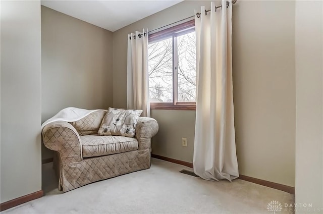 living area featuring carpet floors, visible vents, and baseboards