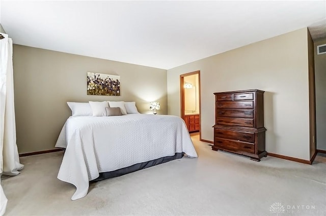 bedroom featuring light carpet, ensuite bathroom, visible vents, and baseboards