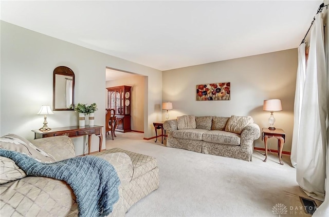 living area with carpet and baseboards